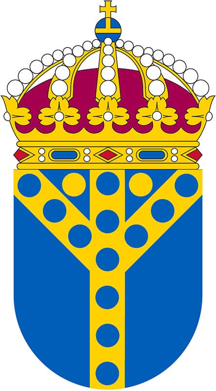 Illustration av vapenskölden för Utbetalningsmyndigheten, som består av en gul krona ovanför en blå sköld. Skölden är dekorerad med ett guldfärgat Y-mönster med prickar, vilket symboliserar organisationens funktion och myndighet.